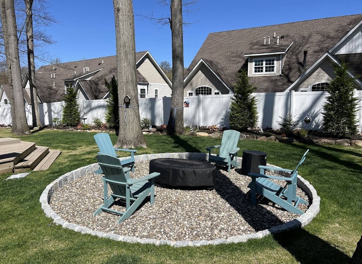 Stone fire pit with Adirondack seating